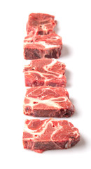 Chunk of cut frozen beef meat over white background 