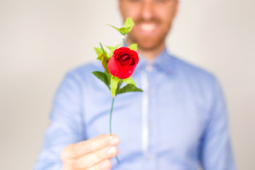 Young man giving a bouquet of roses