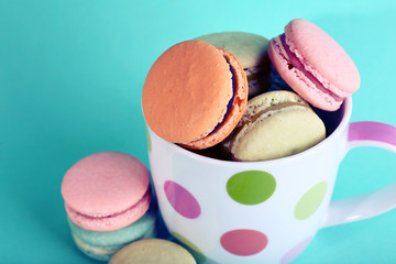 Assortment of gentle colorful macaroons in mug