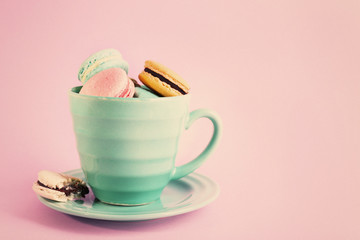 Assortment of gentle colorful macaroons in mug