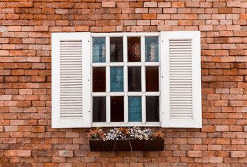 Fototapeta na wymiar window in a red brick wall background