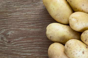 Potatoes on wood background