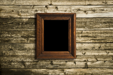 wooden photo frame on old wooden wall