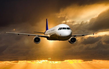 Fototapeta na wymiar A passenger plane flying in the sky at sunset