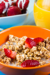 Breakfast with mueasli with fresh fruit and orange juice