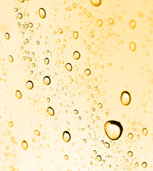 golden water drops on glass