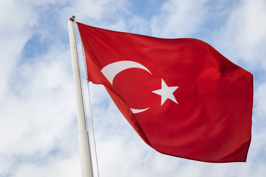 Turkish Flag on a white pole in the wind