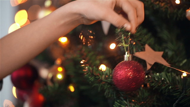 Child girl decorates the Christmas tree. dolly shot