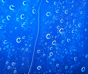 fresh background of water drops on blue surface