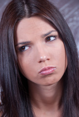 Young brunette woman making face expression