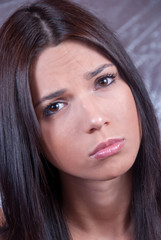 Obraz premium Young brunette woman making face expression