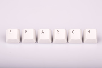 text search formed with computer keyboard keys on white backgrou
