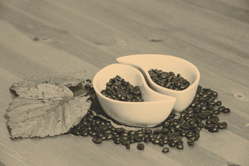 cups with coffee beans on a wooden table