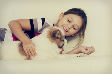 child hugging a puppy