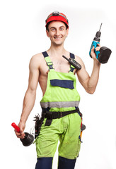 Young handsome workman holding a plunger and a drill