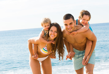 Fototapeta premium Family of four at the beach