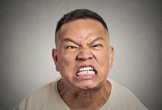 headshot angry middle aged man with open mouth screaming