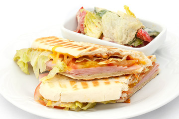 Cheese and ham panini with salad.