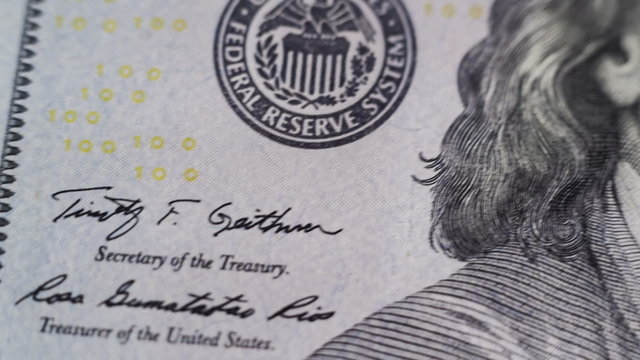 DOLLY MOTION. Close up of new hundred dollar bill.