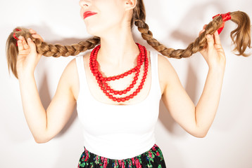 A young beautiful girl wearing folk costume with long tresses