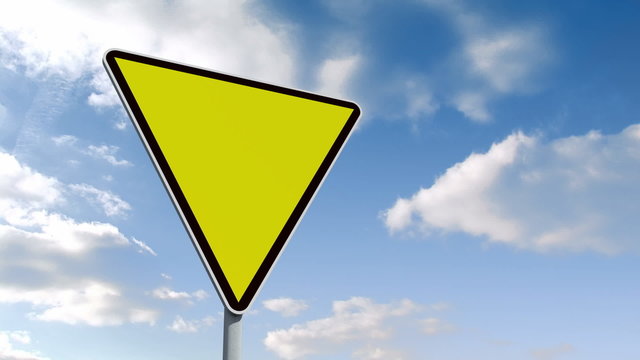 Empty yellow road sign over cloudy sky