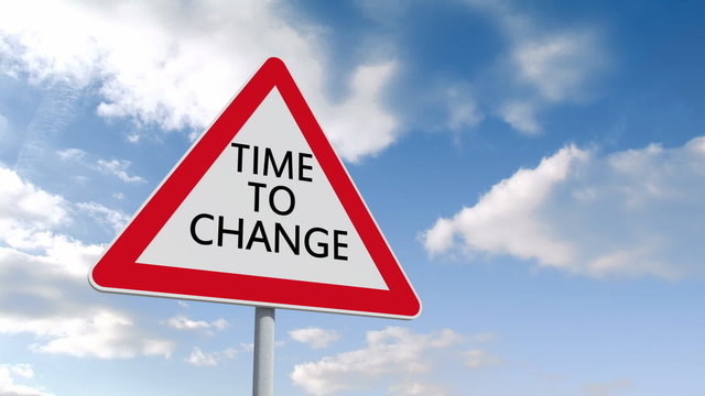 Time to change road sign over cloudy sky