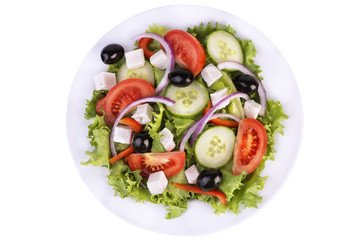 Vibrant Greek salad with fresh cucumbers, tomatoes, red onion, olives, and feta cheese on crisp lettuce, served on a white plate. Perfect for healthy dining, summer meals, or food presentations.