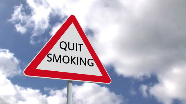 Quit smoking sign against blue sky