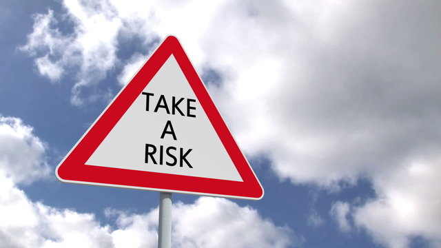 Take a risk sign against blue sky