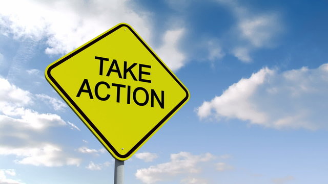 Take action sign against blue sky