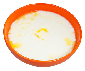 hot semolina porridge with butter in orange bowl