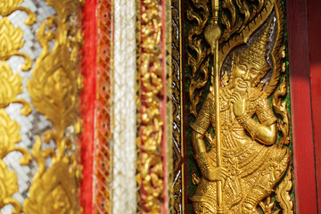 Ancient golden carving wooden window of Thai temple