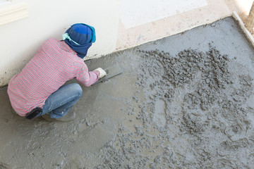 plasterer concrete cement worker plastering flooring of house co