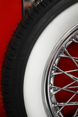 Color vertical shot of a vintage car's spoke wheel.