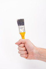 male hand with a yellow brush