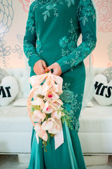 Unknown Malay Bride wearing green dress and holding a bouquet