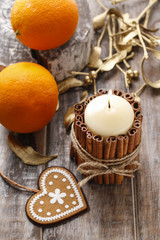 Fototapeta na wymiar Candle decorated with cinnamon sticks, christmas decoration