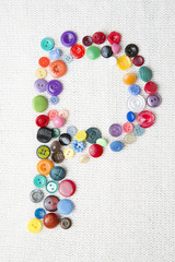 Letter P of the alphabet of buttons of various shapes and colors
