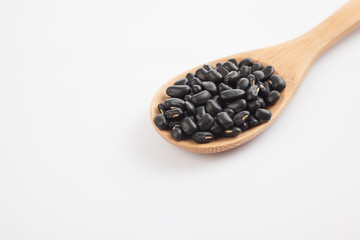 Black beans with wooden spoon