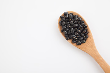 Black beans with wooden spoon