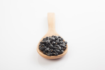 Black beans with wooden spoon