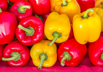 Paprika on red fabric in market.