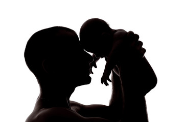 silhouette of father and baby
