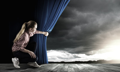 Girl opening curtain