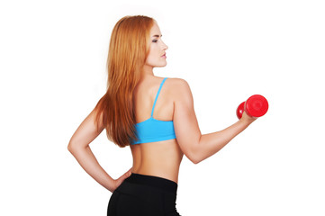 Young fit woman lifting dumbbells on white background