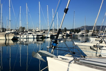 Fototapeta premium sail Boats and yachts reflected in calm marina