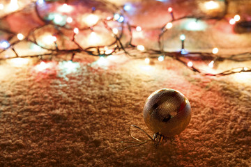 	fur-tree toy and garland on the carpet