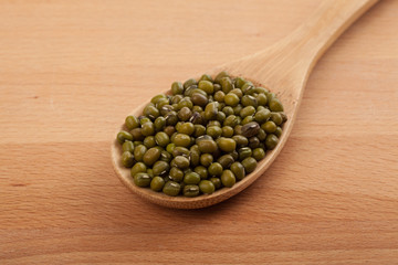 Mung beans with wooden spoon