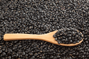 Black beans with wooden spoon