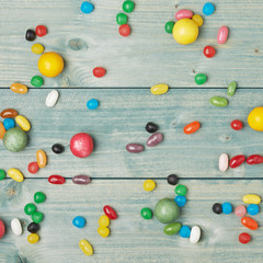 Candies lying over the wooden surface